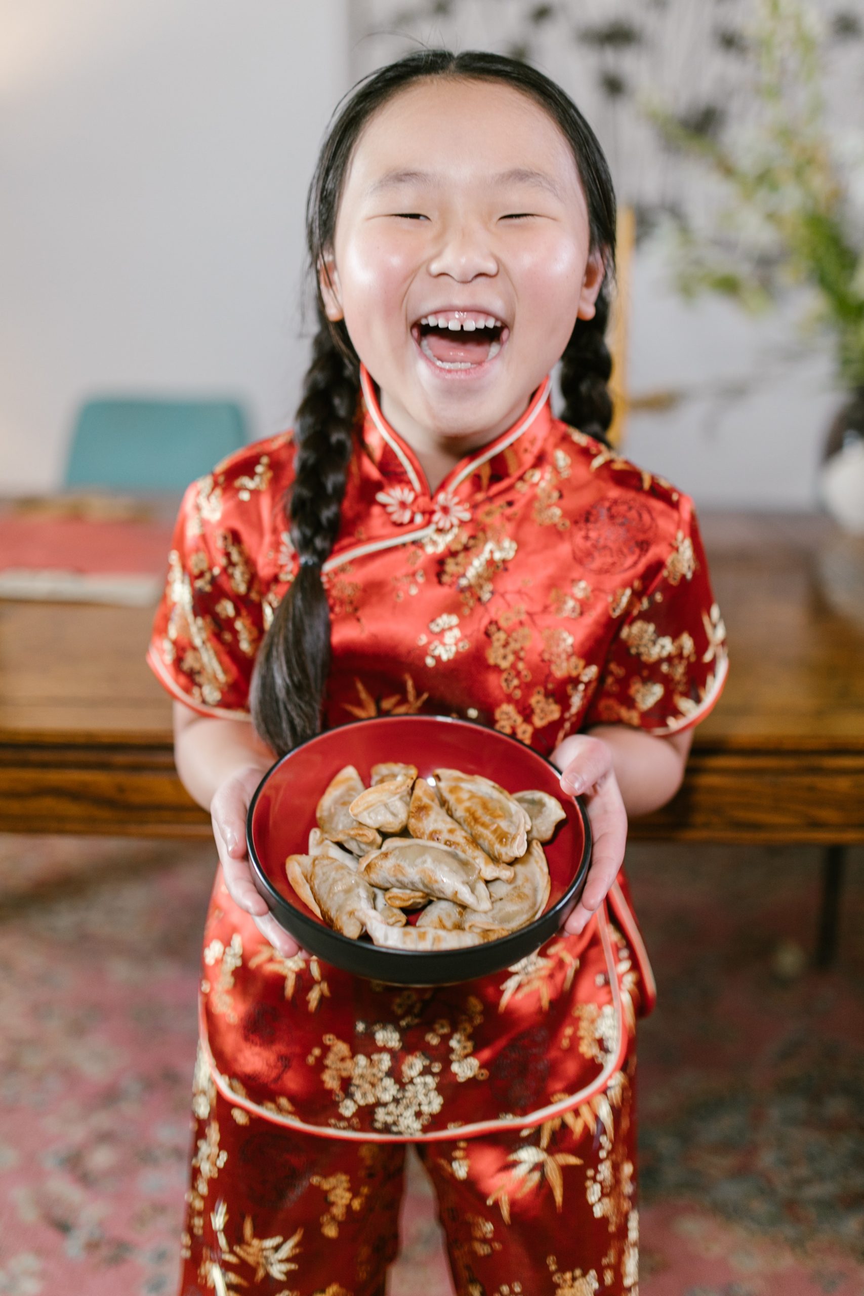 Chinese girl holding traditionally made dumplings
